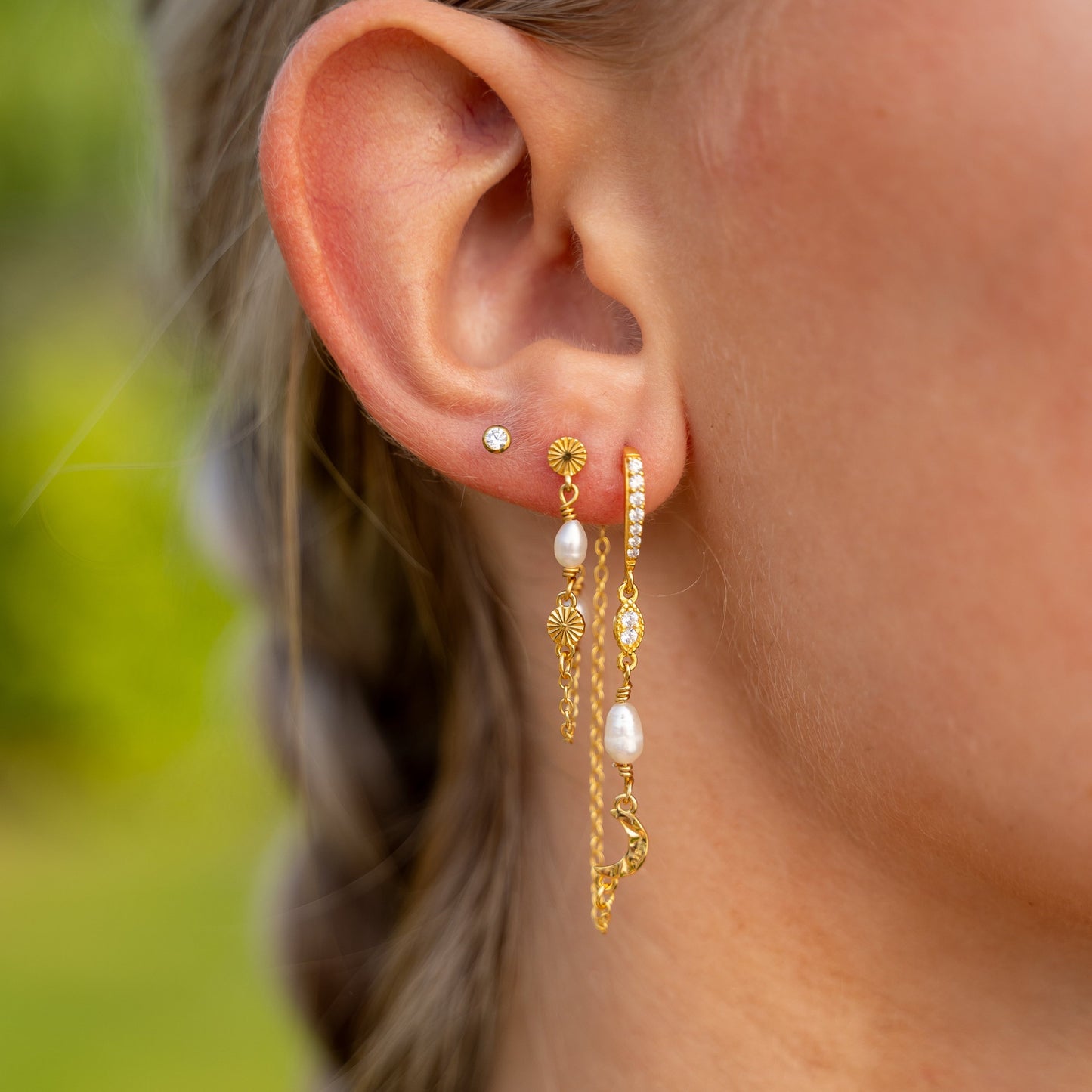 Guldbelagte øreringe ørestikker (behind the ear) med måner, zirkoner og måner i banket blankt design, på model